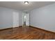 Bedroom with hardwood flooring, neutral walls, and an en-suite bathroom at 3844 Oglesby Rd, Powder Springs, GA 30127