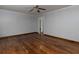 Spacious bedroom featuring beautiful hardwood floors, ceiling fan and fresh gray paint at 3844 Oglesby Rd, Powder Springs, GA 30127