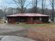 Charming ranch home with a red roof, natural wood shingle, and inviting front porch at 3844 Oglesby Rd, Powder Springs, GA 30127