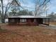 Cozy single-story home featuring a covered carport and a quaint front porch at 3844 Oglesby Rd, Powder Springs, GA 30127