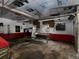Interior view of garage featuring a dirty floor, red trim, ladder, and various tools at 3844 Oglesby Rd, Powder Springs, GA 30127