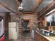Interior view of a rustic kitchen with vintage appliances and log cabin walls at 3844 Oglesby Rd, Powder Springs, GA 30127