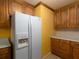 Kitchen featuring wooden cabinets, white appliances, and a full size refrigerator at 3844 Oglesby Rd, Powder Springs, GA 30127