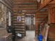 Interior view of a log cabin living room with wood paneled walls, stairs, and decor at 3844 Oglesby Rd, Powder Springs, GA 30127