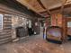 Interior view of a rustic living room with a stone fireplace and wood-paneled walls at 3844 Oglesby Rd, Powder Springs, GA 30127