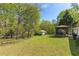 Lush backyard showcasing a gazebo, outbuilding, and various trees, offering a peaceful outdoor space at 5369 Blue Grass Ln, Sugar Hill, GA 30518