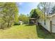Expansive backyard featuring a gazebo, outbuilding, and lush green lawn at 5369 Blue Grass Ln, Sugar Hill, GA 30518