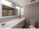 Bright bathroom featuring a double sink vanity, large mirror, and bathtub with shower at 5369 Blue Grass Ln, Sugar Hill, GA 30518