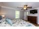 Traditional bedroom featuring hardwood floors, a ceiling fan, and large windows at 5369 Blue Grass Ln, Sugar Hill, GA 30518