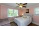 Light and airy bedroom featuring hardwood floors, a ceiling fan, and neutral wall color at 5369 Blue Grass Ln, Sugar Hill, GA 30518
