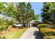 Lovely home with a well-kept lawn, mature landscaping, and a convenient carport for easy access at 5369 Blue Grass Ln, Sugar Hill, GA 30518
