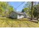 Charming home showcasing a well-maintained lawn and surrounded by mature trees at 5369 Blue Grass Ln, Sugar Hill, GA 30518
