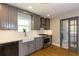 Updated kitchen features gray cabinets, stainless steel appliances, and a farmhouse sink at 5369 Blue Grass Ln, Sugar Hill, GA 30518