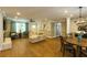Bright, open living space featuring hardwood floors, stylish furniture, a fireplace, and a view of the dining area at 5369 Blue Grass Ln, Sugar Hill, GA 30518