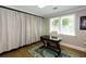 Home office with hardwood floors, bright natural light, and built-in storage at 5369 Blue Grass Ln, Sugar Hill, GA 30518