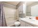 Bathroom with shower-tub combo, white vanity, toilet and gray flooring at 7617 Lakemoor Dr, Riverdale, GA 30296