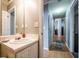 Bathroom featuring vanity, sink, cabinets, and a hallway with a door, offering functionality at 7617 Lakemoor Dr, Riverdale, GA 30296