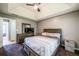 Bedroom features tray ceiling, fan, plush carpet, and neutral walls at 7617 Lakemoor Dr, Riverdale, GA 30296