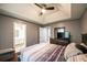 Bedroom with en suite bathroom, tray ceiling, ceiling fan, and neutral colored walls at 7617 Lakemoor Dr, Riverdale, GA 30296