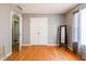 Bedroom with hardwood flooring, neutral colored walls, and a double door closet at 7617 Lakemoor Dr, Riverdale, GA 30296