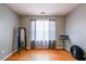 Bedroom with hardwood flooring, neutral colored walls, and large window allowing for natural light at 7617 Lakemoor Dr, Riverdale, GA 30296