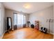 Bedroom with hardwood flooring, neutral colored walls, and large window allowing for natural light at 7617 Lakemoor Dr, Riverdale, GA 30296