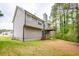 Two-story house featuring a raised deck, siding, and well-maintained lawn backing to wooded area at 7617 Lakemoor Dr, Riverdale, GA 30296
