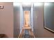 Hallway with hardwood floors leading to a full bathroom with tile flooring at 7617 Lakemoor Dr, Riverdale, GA 30296
