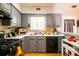 Well-lit kitchen with gray cabinets, white countertops, and modern appliances at 7617 Lakemoor Dr, Riverdale, GA 30296