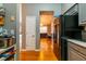 Galley kitchen with stainless steel appliances and hardwood floors leading to the living room at 7617 Lakemoor Dr, Riverdale, GA 30296