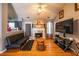 Cozy living room features hardwood floors, a fireplace, and modern entertainment setup at 7617 Lakemoor Dr, Riverdale, GA 30296
