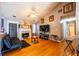 Bright living room with vaulted ceiling, hardwood floors, fireplace, and neutral paint at 7617 Lakemoor Dr, Riverdale, GA 30296