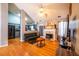 Inviting living room flows into the kitchen, featuring hardwood floors and a fireplace at 7617 Lakemoor Dr, Riverdale, GA 30296