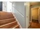 Staircase featuring wood steps and a white handrail leading up to the entrance at 7617 Lakemoor Dr, Riverdale, GA 30296