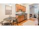 Compact kitchen area with wood cabinets, stainless steel appliances, and adjacent dining space at 1015 Piedmont Ne Ave # A2, Atlanta, GA 30309