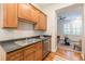 Well-appointed kitchen with wooden cabinets and view into bright living room at 1015 Piedmont Ne Ave # A2, Atlanta, GA 30309
