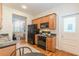 Functional kitchen showcasing wood cabinets, modern appliances and view into the living room at 1015 Piedmont Ne Ave # A2, Atlanta, GA 30309