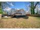 A fenced backyard featuring a well-maintained lawn and a wooden deck with stairs for outdoor entertaining at 1947 Maywood Nw Pl, Atlanta, GA 30318