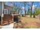 Spacious backyard with steps leading to deck and view of grass and trees at 1947 Maywood Nw Pl, Atlanta, GA 30318