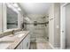 Bathroom featuring double vanity, granite counters, and glass-enclosed shower with tiled walls at 1947 Maywood Nw Pl, Atlanta, GA 30318