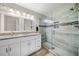 Modern bathroom featuring double vanity, granite counters, and glass-enclosed shower with tiled walls at 1947 Maywood Nw Pl, Atlanta, GA 30318