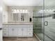 Bathroom featuring double vanity, granite counters, and glass-enclosed shower with tiled walls at 1947 Maywood Nw Pl, Atlanta, GA 30318