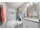Bathroom features a shower over tub, tile surround and vanity with granite counter at 1947 Maywood Nw Pl, Atlanta, GA 30318