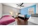 Bright bedroom with hardwood floors, fun accent wall, ceiling fan, and natural light at 1947 Maywood Nw Pl, Atlanta, GA 30318