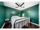 Bedroom with dark green walls, hardwood floors, and a ceiling fan at 1947 Maywood Nw Pl, Atlanta, GA 30318