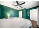 Bedroom with dark green walls, hardwood floors, and a ceiling fan at 1947 Maywood Nw Pl, Atlanta, GA 30318