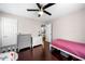 Bright bedroom with hardwood floors, ceiling fan, and an adjacent kitchen at 1947 Maywood Nw Pl, Atlanta, GA 30318
