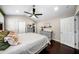This bedroom has hardwood floors, a ceiling fan, and neutral-colored walls at 1947 Maywood Nw Pl, Atlanta, GA 30318