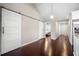 Hallway features hardwood floors and sliding barn doors leading to bedrooms and kitchen at 1947 Maywood Nw Pl, Atlanta, GA 30318
