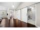 Hallway features hardwood floors and sliding barn doors leading to a laundry room and bathroom at 1947 Maywood Nw Pl, Atlanta, GA 30318